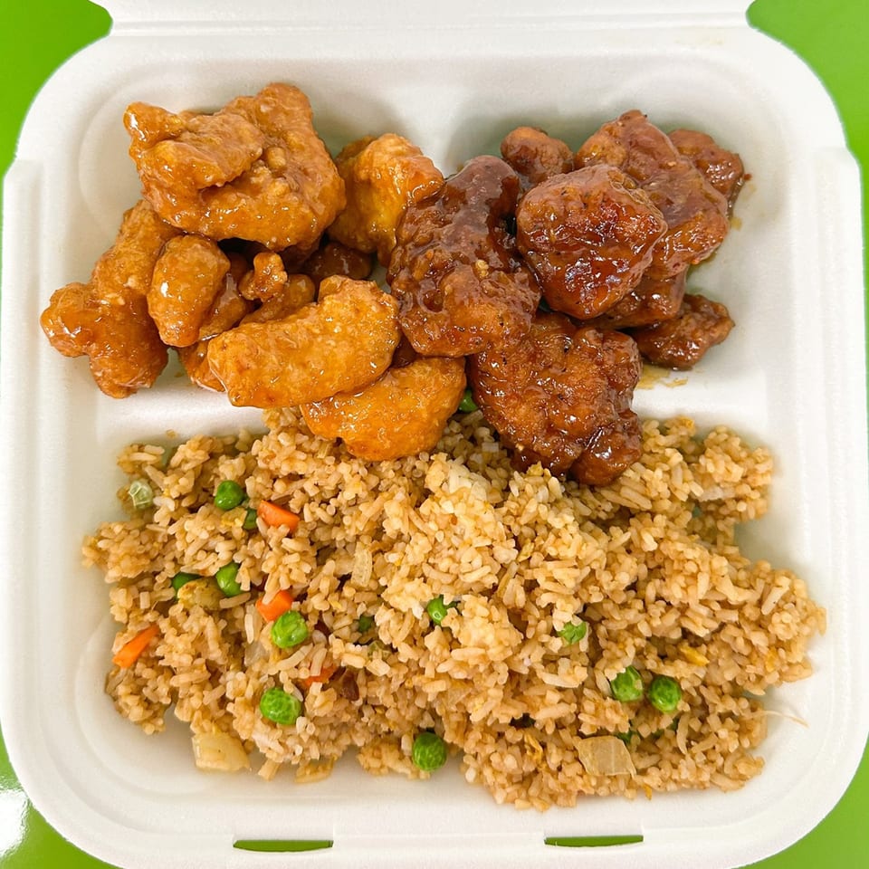 Zing's orange chicken and General Tso's chicken with fried rice in a white takeout container.